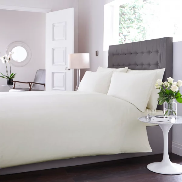 Sestina Ivory Duvet Cover on a bed in a brightly lit bedroom