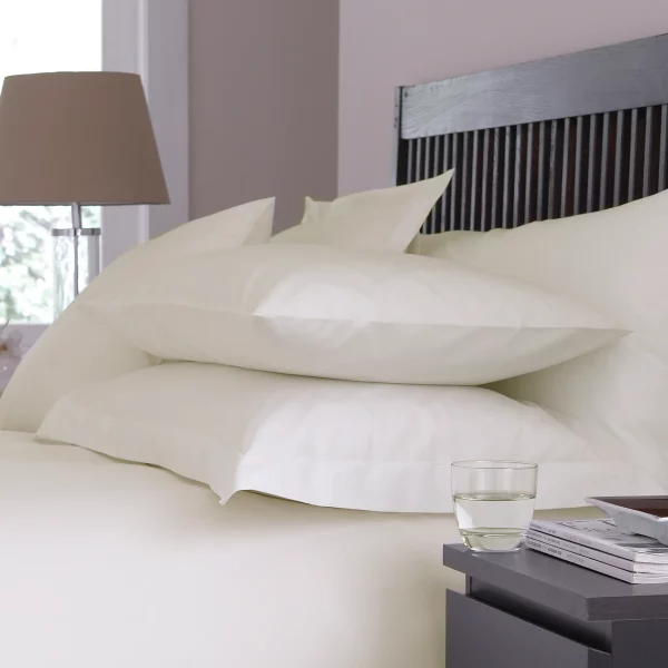 Martex Sestina Ivory Classic Pillowcases covering pillows on a bed