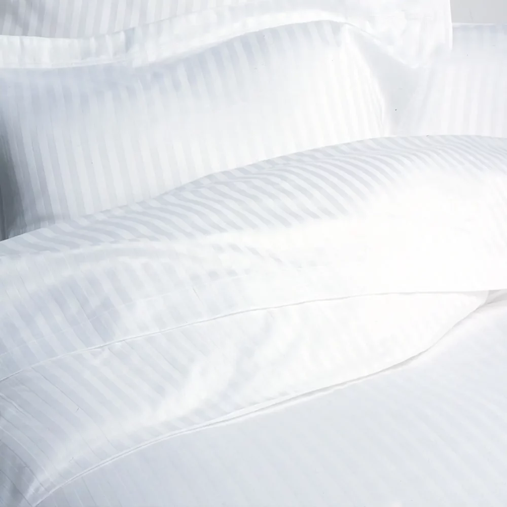 A close up of a satin stripe cotton duvet cover from Liddell