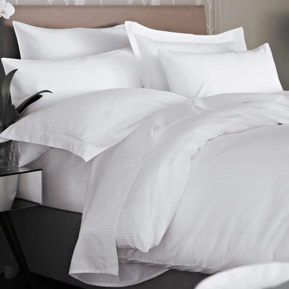 Another angle of a 100% cotton white duvet cover with a 5mm satin stripe design. From Liddell.
