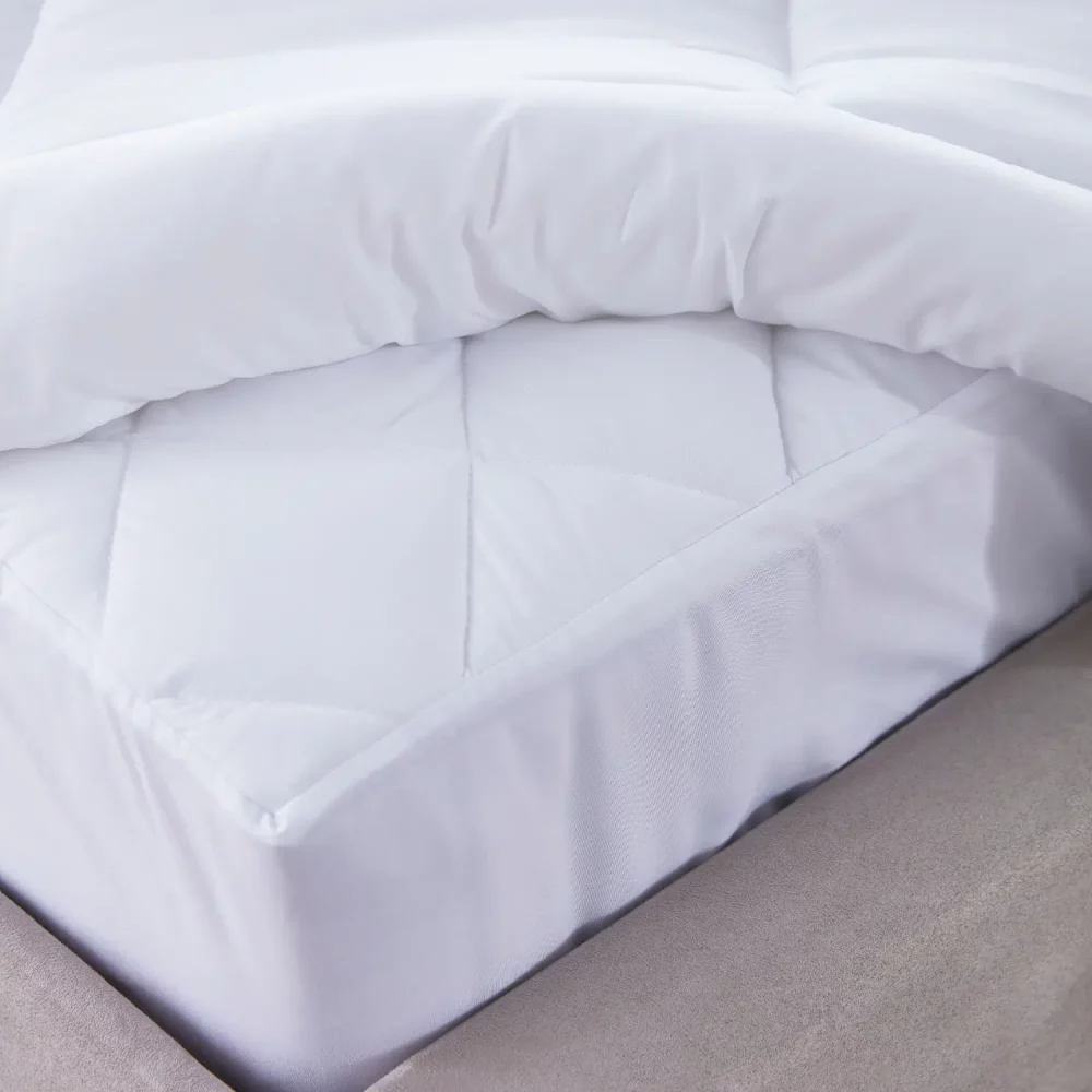 A close up of the edge of a super soft ecopure recycled 100% microfibre mattress protector