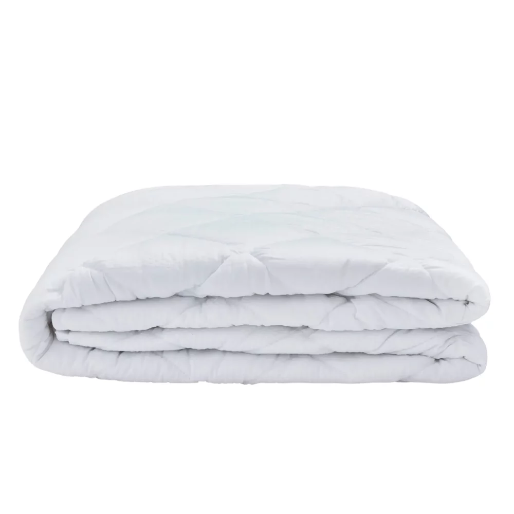A Vision Essentials 100% cotton quilted mattress protector folded up.