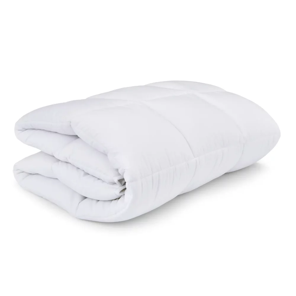 A Martex cosy touch mattress topper folded up on a white background.