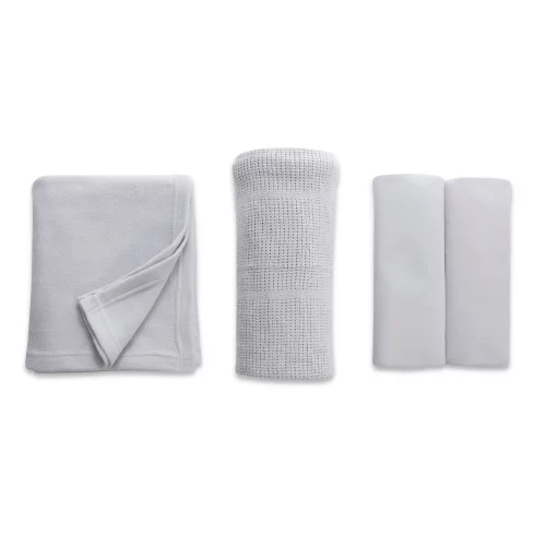 A grey cot bed starter set from Clair De Lune. It contains a fitted sheet, cellular blanket, and polar fleece blanket.