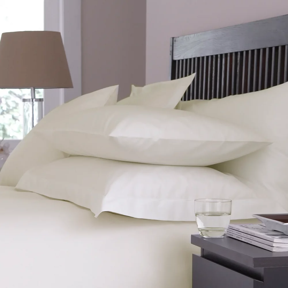 Martex Sestina Ivory Classic Pillowcases covering pillows on a bed