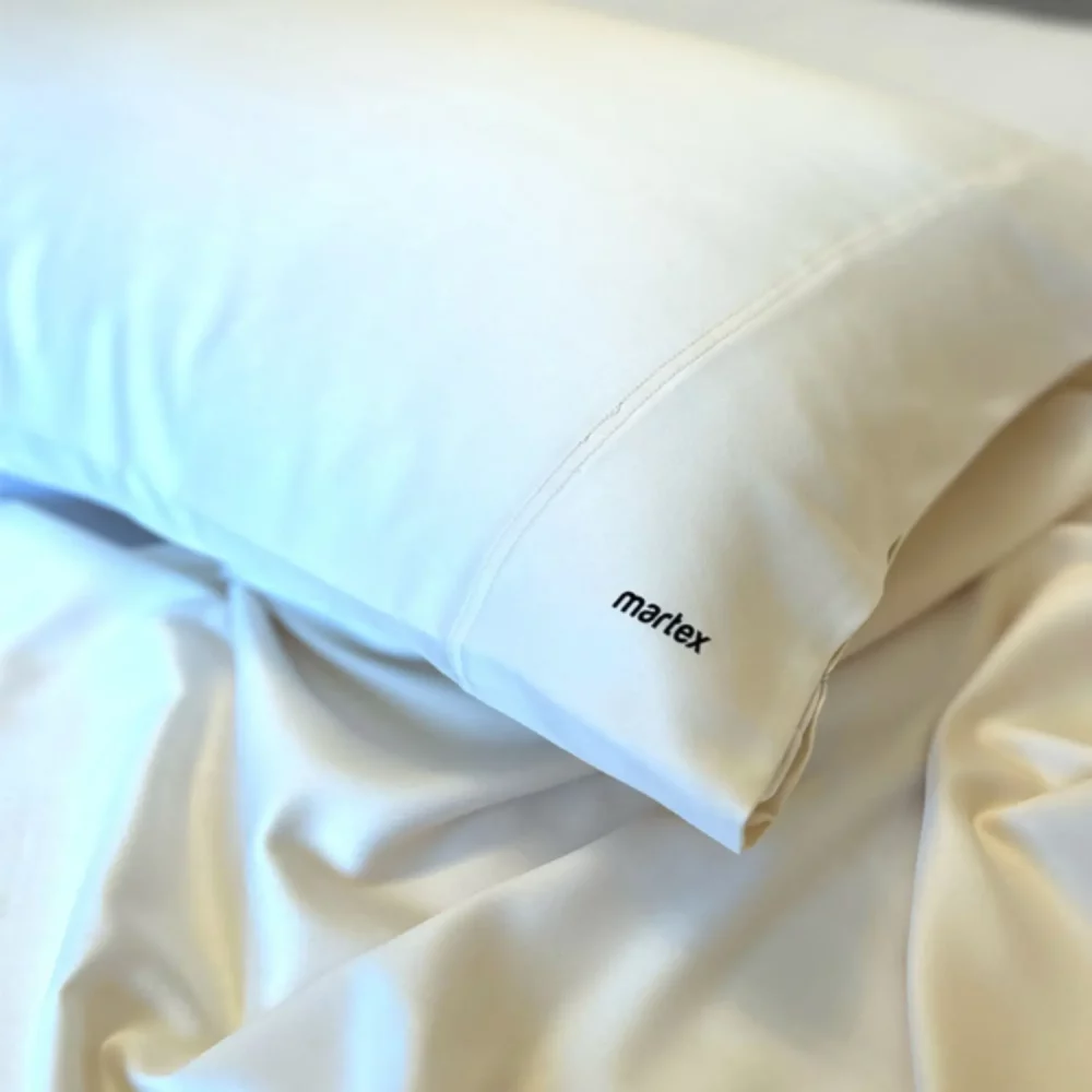 Close up of Martex Satin Travel Pillowcase covering a pillow on a bed
