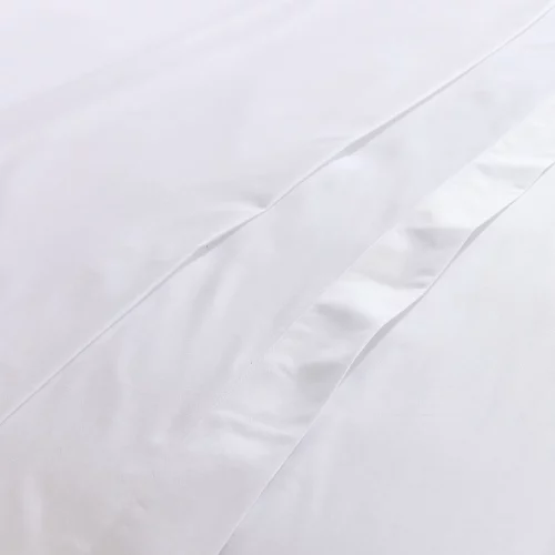 A close up of a white Hotel Pure Luxury branded cotton rich percale flat bed sheet.