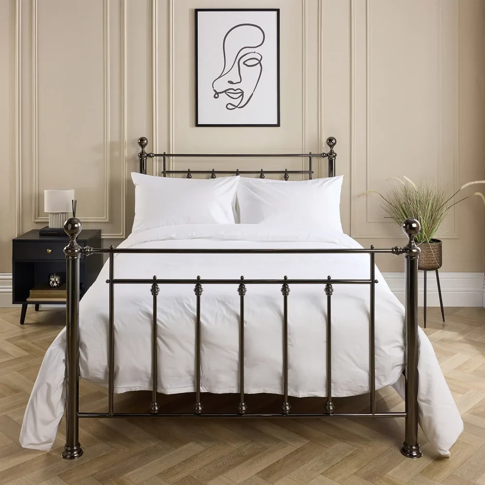 Hotel Pure Luxury cotton rich percale extra long duvet cover on a metal framed bed in a contemporary bedroom. There are also pillows on the bed. There is a dark wood cabinet with a lamp on top on the left-hand side of the room, with a painting above the bed.